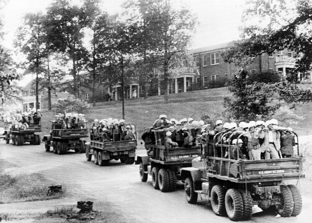 U.S. Army trucks roll across the University of Mississippi campus in the wake of the riots when Meredith entered